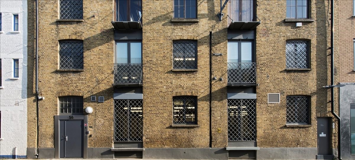 Exterior view of the traditional yellow brick facade of 56 Ayres Street, Central London.