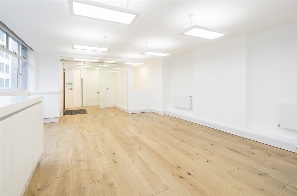 Spacious, bright interior office space at 6-8 Emerald Street with light wood flooring and overhead panel lighting.