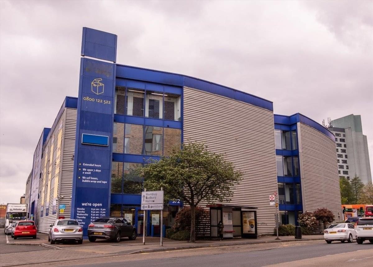 Exterior facade of the blue and grey Access Offices, 372 Ealing Road building with street parking.