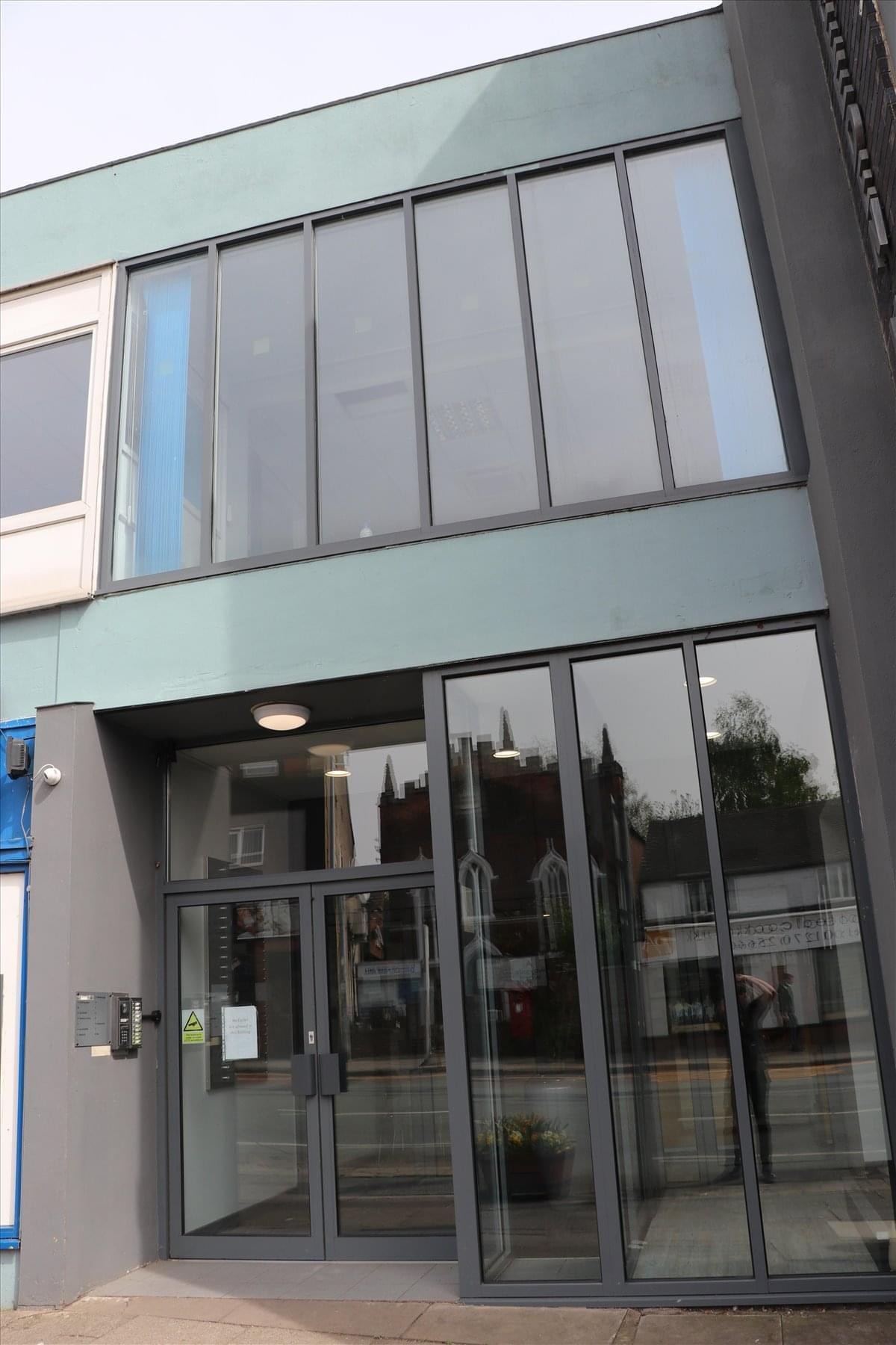 Exterior view of the modern glass and teal facade of Breeden House, 245-265 Edleston Road.