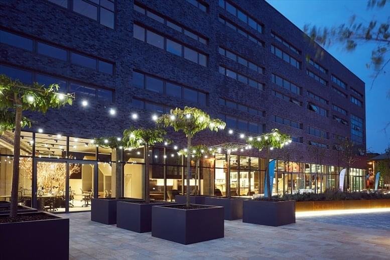 Night view of the brick facade of Bright Building, Pencroft Way, Manchester with string lights.