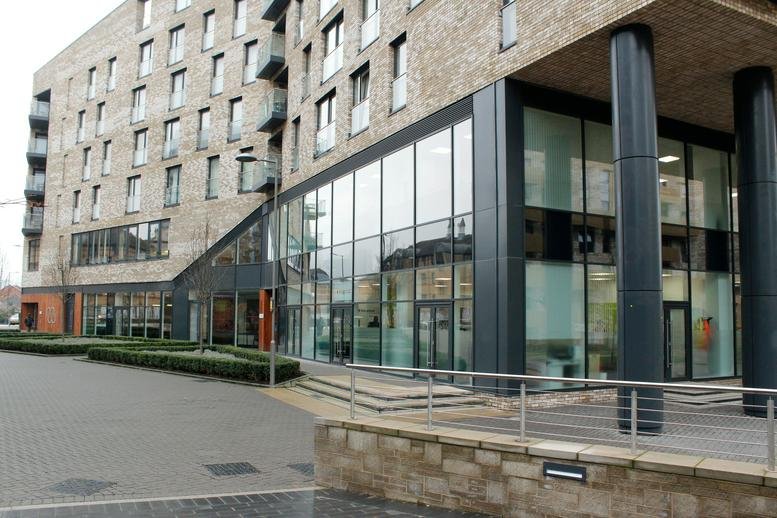Exterior view of the modern brick facade and glass entrance at Cadmus Court, Plough Way.