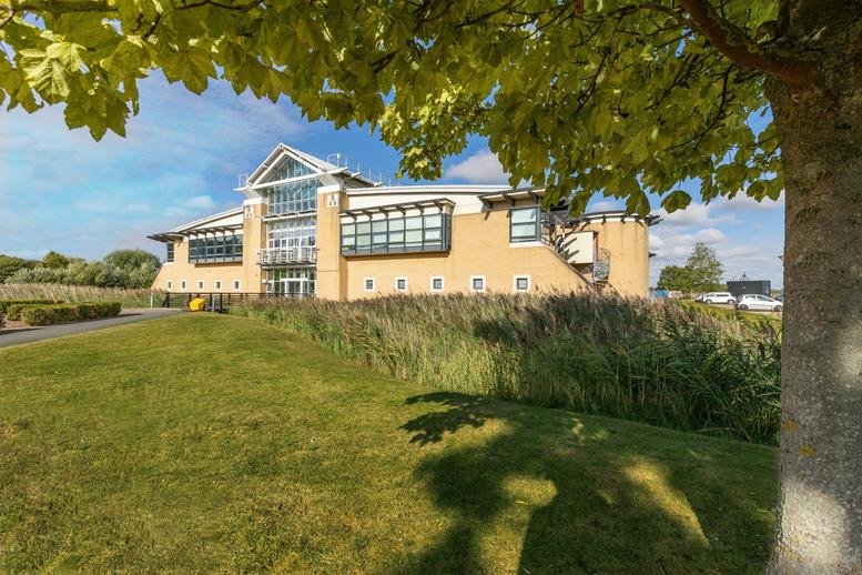 Exterior view of the brick facade and gabled entrance at Stirling House, Cambridge Innovation Parks.