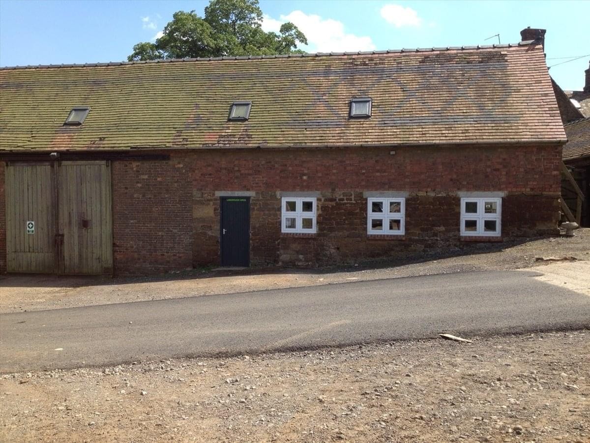 Exterior view of the brick facade and pitched roof at The Old Workshop, Cold Ashby Road, Guilsborough.