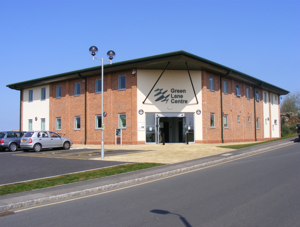 Exterior view of the Green Lane Centre showing the main entrance and parking.