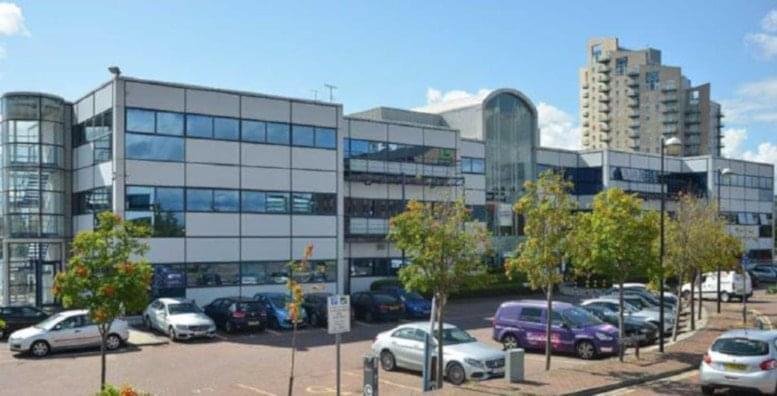 Exterior view of the modern glass and stone facade at Media Village, Waterfront Quay, Manchester.