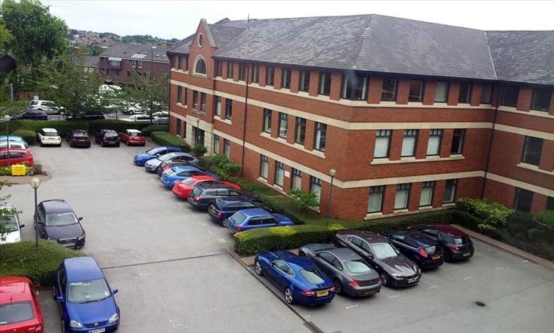 Exterior view of the brick facade and parking area at 1 Woodborough Road.