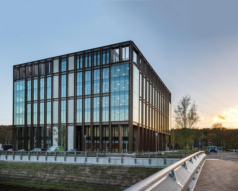 Exterior view of the glass-facade Number One, Kirkstall Forge building at sunset.