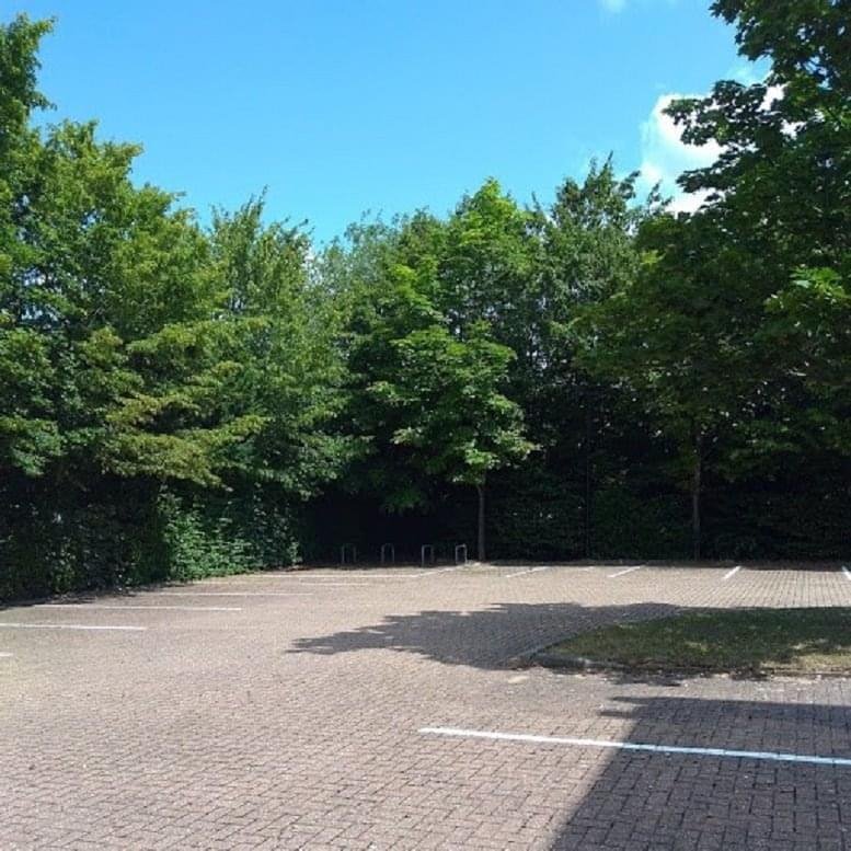 Exterior view of the paved parking area and mature green trees at Phoenix House.