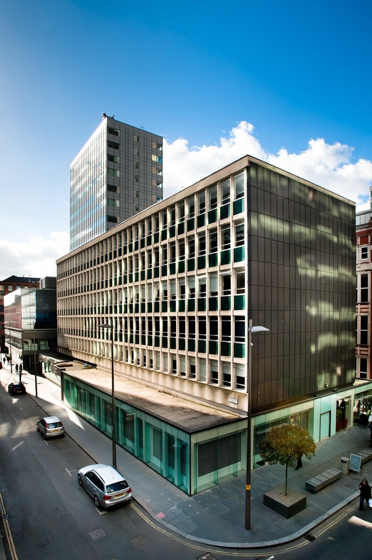 Exterior view of the modernist grey and glass facade at Bank Chambers, Faulkner Street, Manchester.
