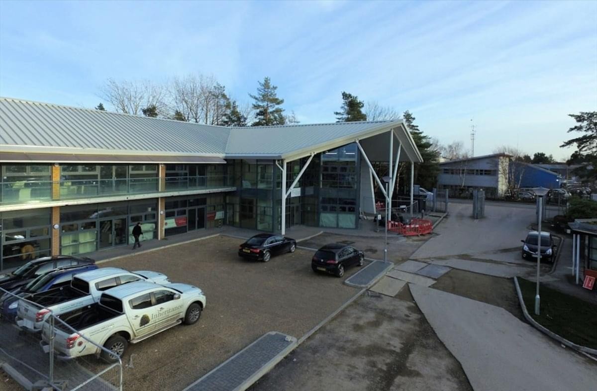 Exterior view of the modern glass and steel facade at Stirling House, Denny End Road.