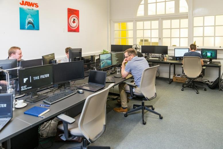 Spacious open-plan workspace at The Guild, High Street, Bath, Somerset with desks and natural light.