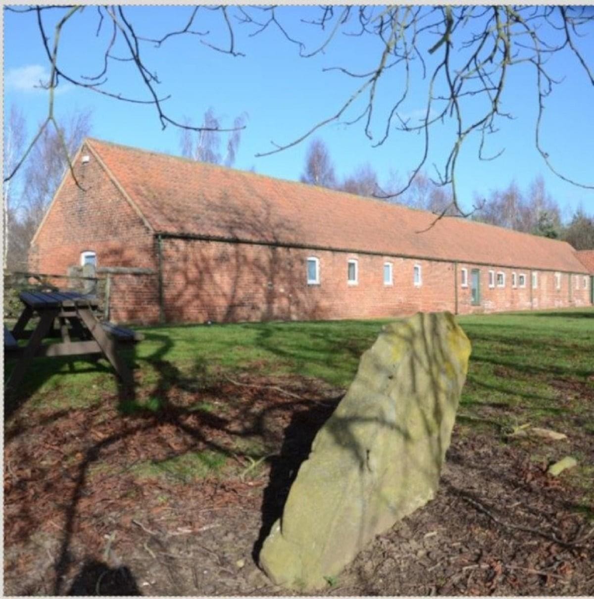 Exterior view of the long brick barn conversion known as The Menagerie, Skipwith Road.