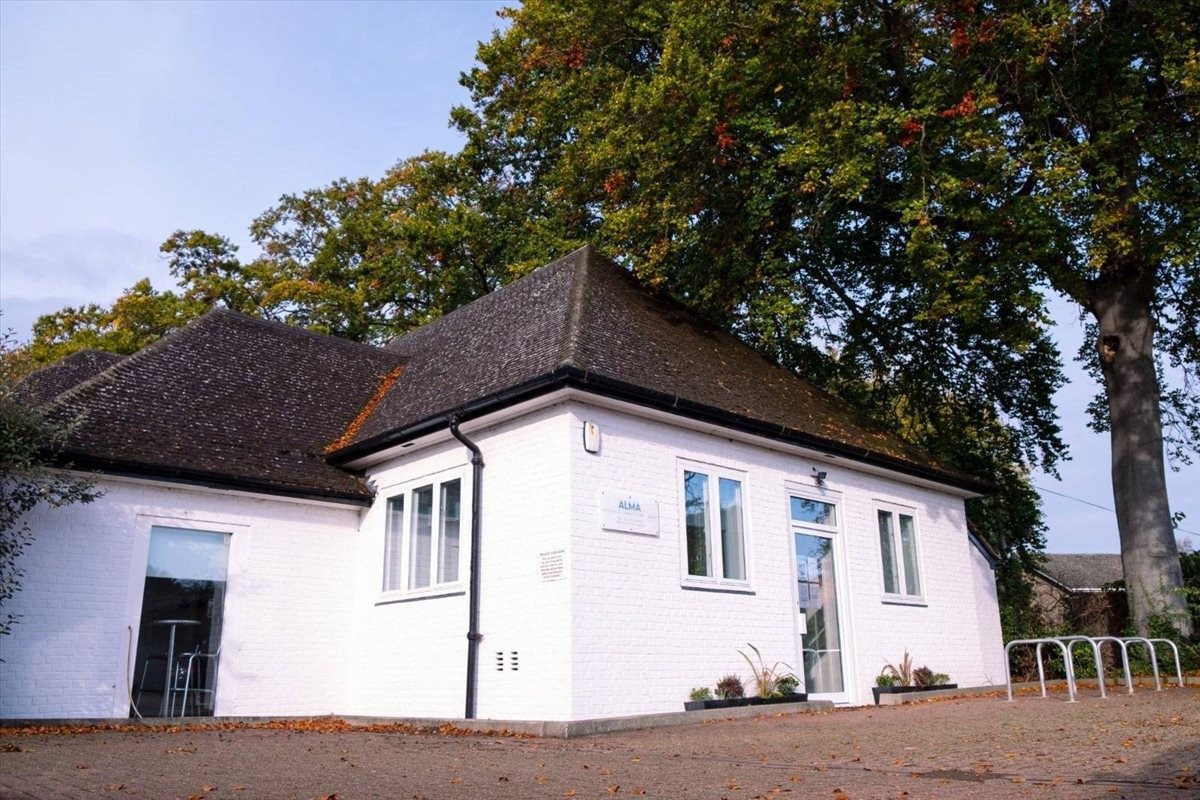 Exterior view of the white-walled building and tiled roof at The Studio High, Maris Green, Great Shelford.