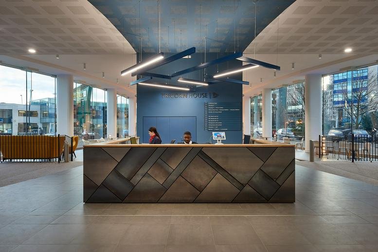 Lobby at Tricorn Studios, Tricorn House, Edgbaston featuring a geometric reception desk and blue feature wall.