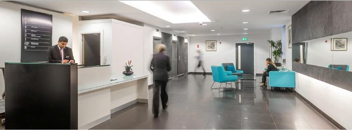Modern reception lobby at West Gate, Grace Street, Leeds, West Yorkshire with sleek black desk and seating areas.