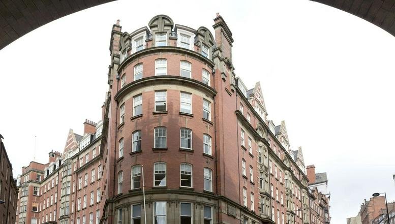 Exterior view of the historic red brick facade of Milburn House, Dean Street.