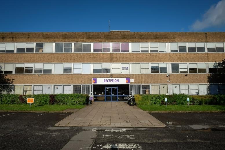 Exterior view of the brick facade and entrance at Moulton Park Business Centre, Northampton.