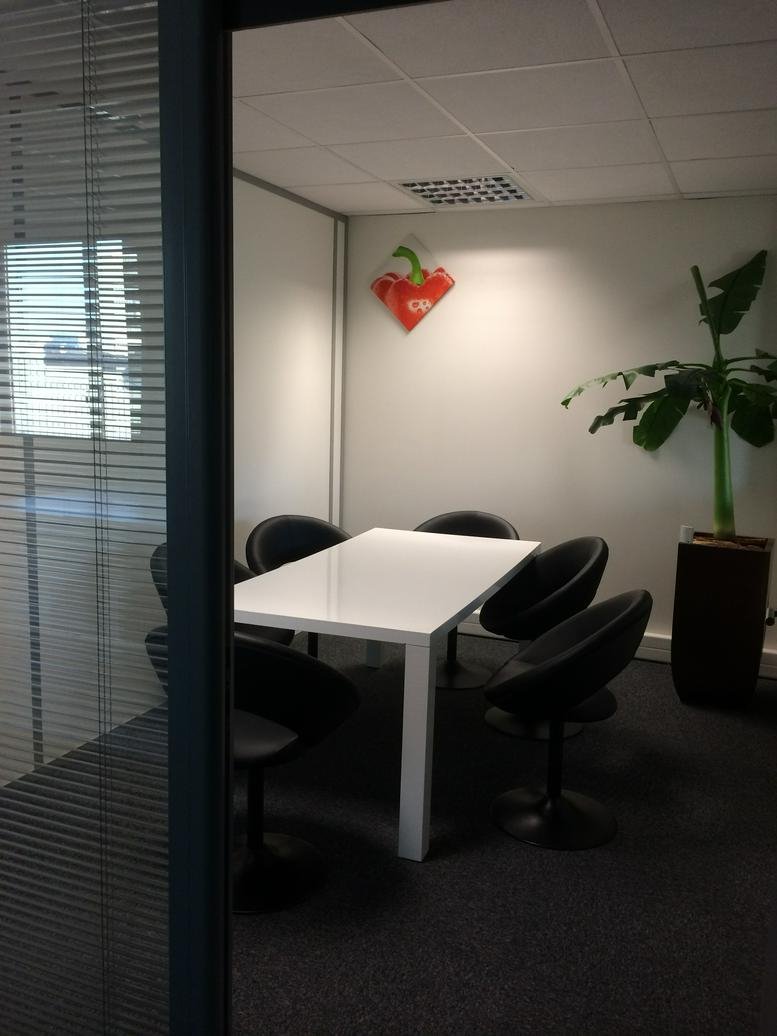 Meeting room with a white table, black chairs, and a potted banana plant at 1 Rue Des Pins, Arc En Ciel.