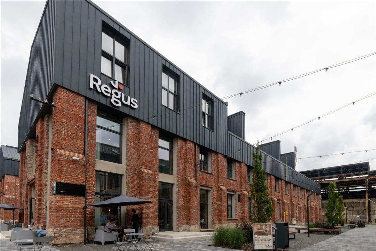 Exterior view of the brick and black-metal building at 120 Shevchenko Street, Lviv.