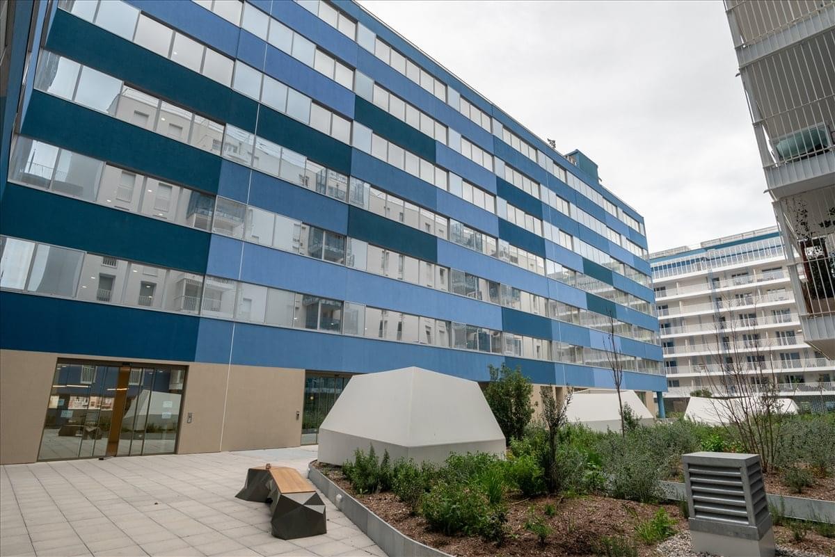Modern exterior of the blue-panelled building at 132 Boulevard Michelet.
