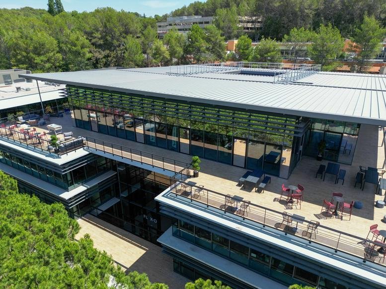 Aerial view of a contemporary office building with extensive outdoor terraces.