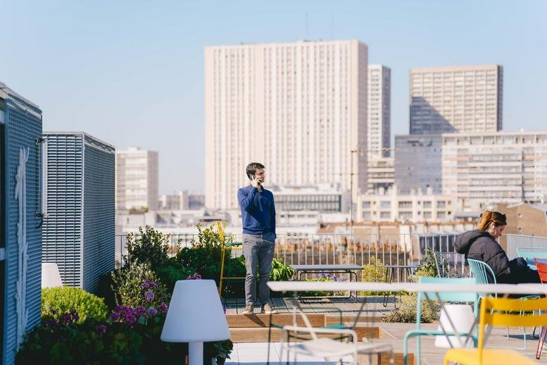 Rooftop terrace at 25-27 Rue De Tolbiac, Paris with seating and panoramic city views.