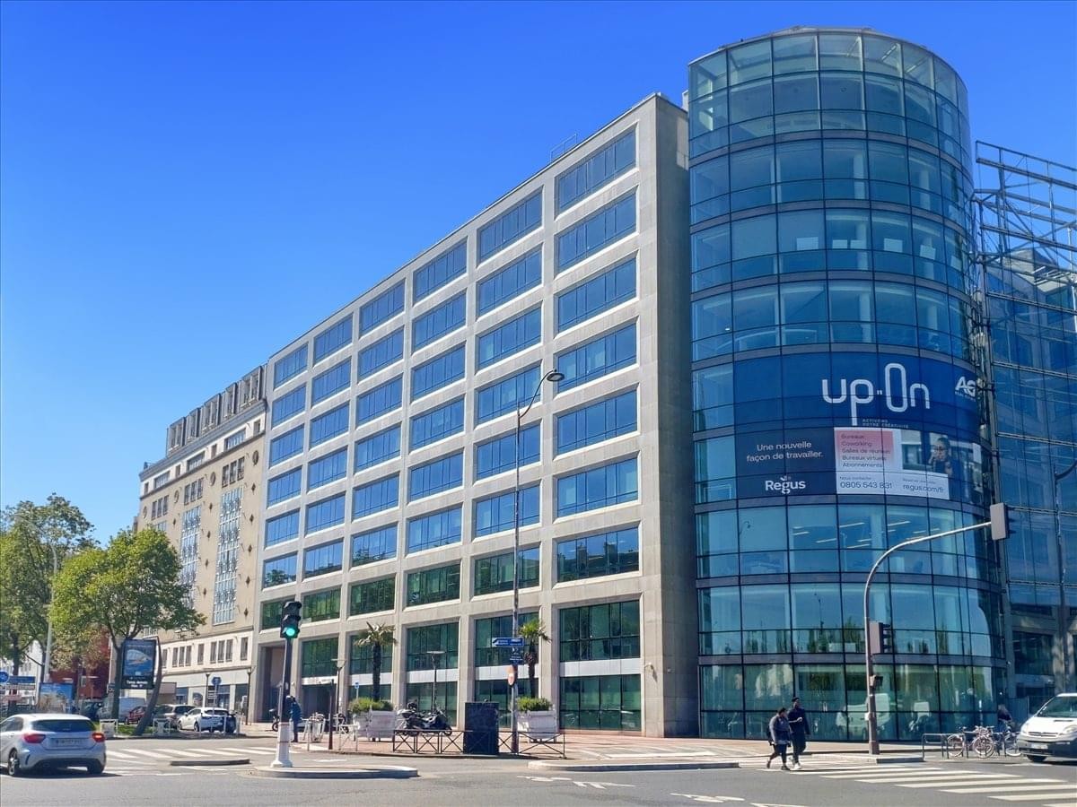 Exterior view of the modern glass and stone facade at 25 Boulevard Romain Rolland.