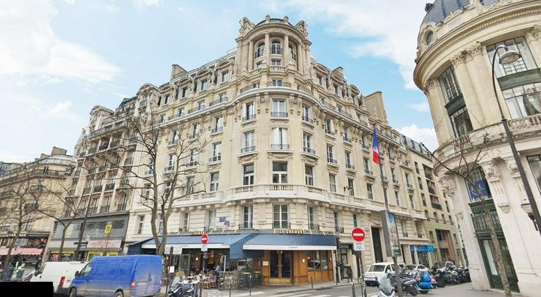 Grand stone exterior building facade of 30 Rue de Gramont, Paris with ornate architectural details.