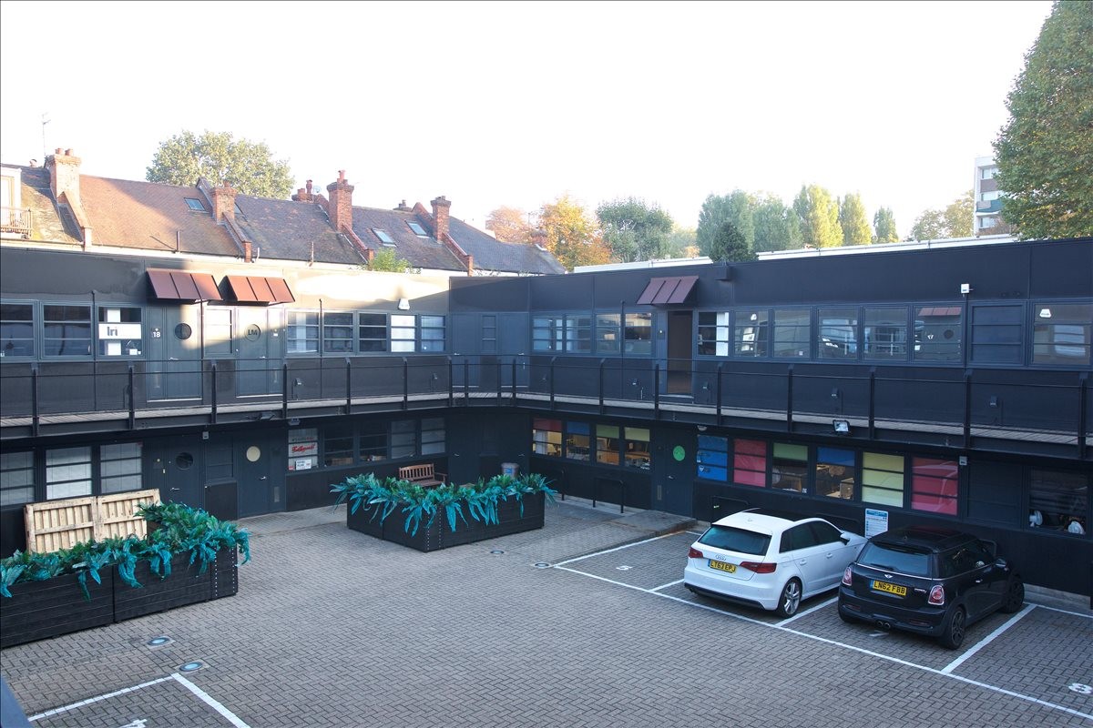 Exterior courtyard view of the dark-facade Spectrum House at 32-34 Gordon House Road.