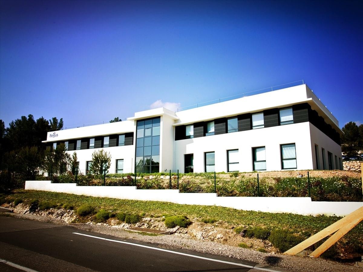 Exterior view of the modern white office building at Parc du Golf.