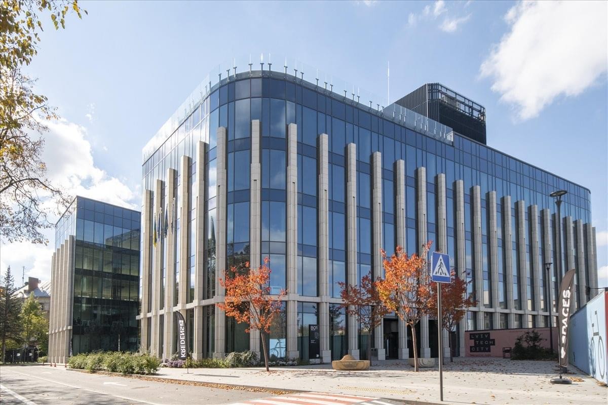 Exterior view of the glass and stone modern facade at 48 Stryjska Str, Lviv, Ukraine.
