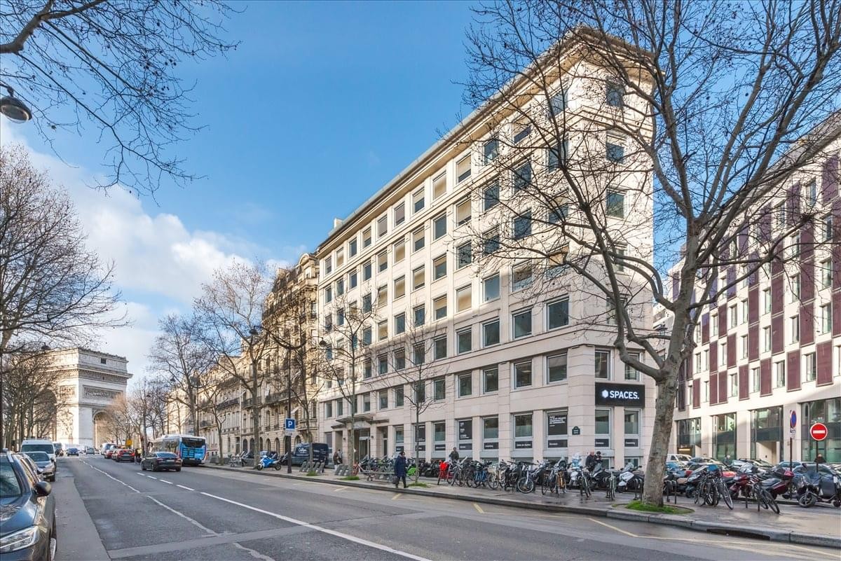 Exterior view of the classic stone facade at 54/56 avenue Hoche, Paris with tree-lined streets.