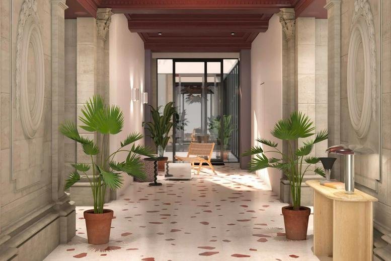 Grand entrance at 6 Rue Cambacérés featuring tall stone pillars, potted palms, and patterned terrazzo flooring.