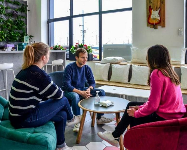 Spacious communal lounge at 74 Rue de Paris, Noisy-le-Sec, Seine-Saint-Denis with natural light and green plant wall.