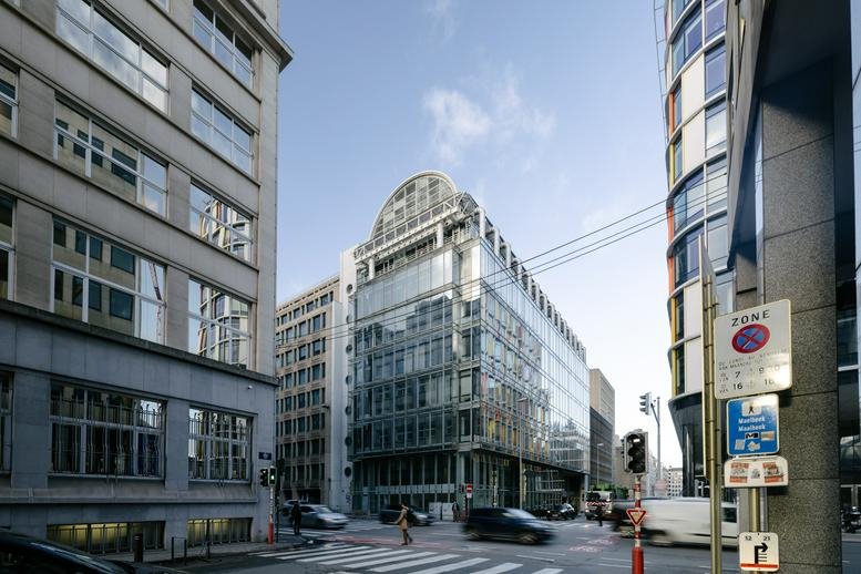 Exterior view of the glass and stone building at 74, Rue de Trèves, Brussels.