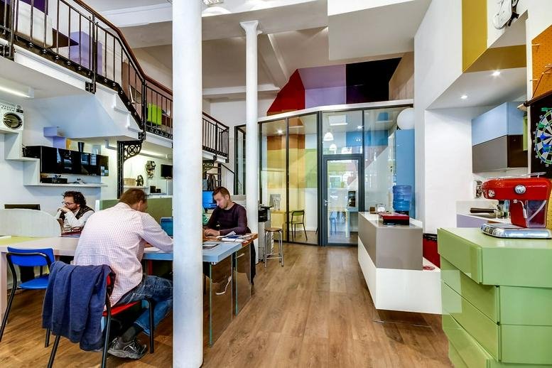 Spacious communal coworking area at 8 Rue de Clery Paris 2e with industrial mezzanine and natural light.
