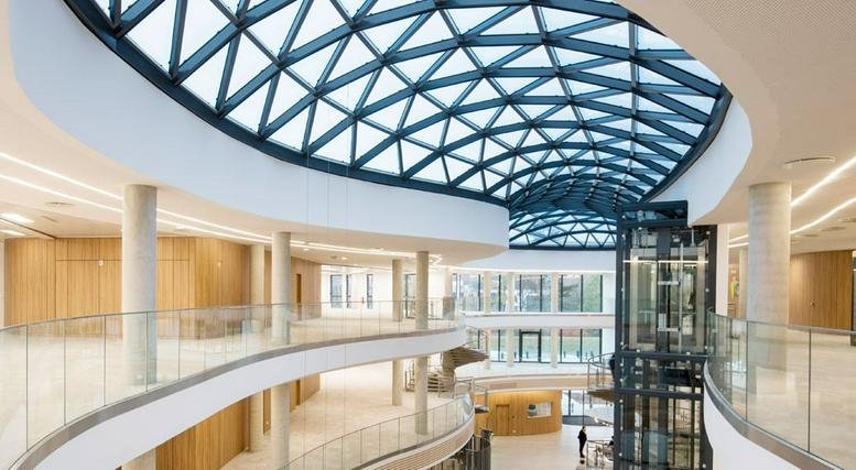 Spacious sun-drenched atrium with a geometric glass roof at 81 rue du Sans Souci, Lyon, Rhone.