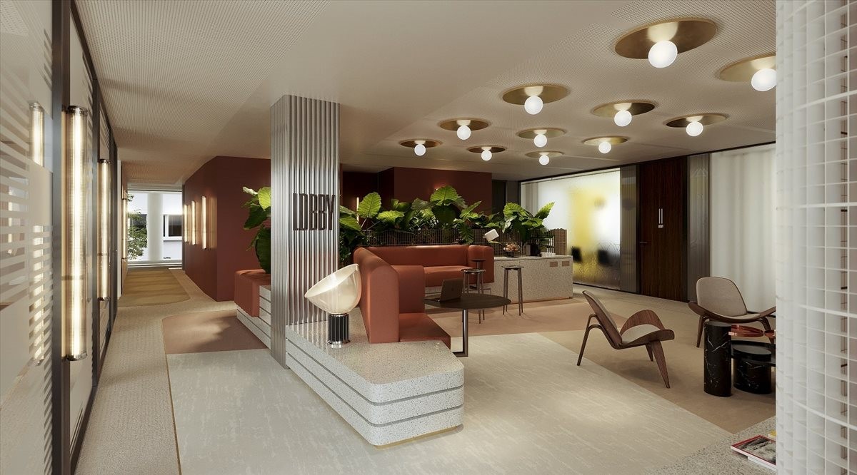 Spacious contemporary lobby at 9 Rue des Cuirassiers with recessed lighting and warm lounge seating.