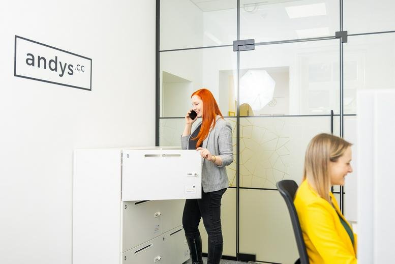 Bright reception area at Bahnhofstrasse 8, Bad Ischl with glass partitions and branded signage.
