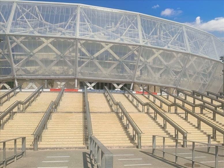 Close-up of the stadium's external stairs leading to the white lattice facade.