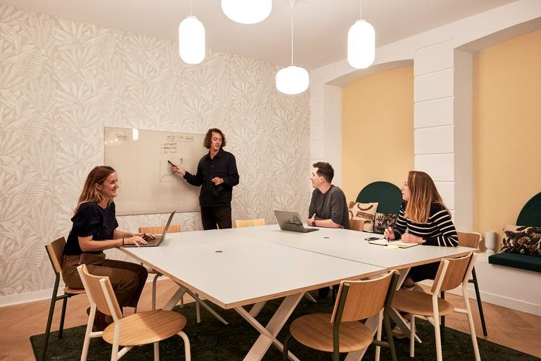 Meeting room at Cléry, 21 Rue de Cléry, Paris with colleagues gathered around a large white table.