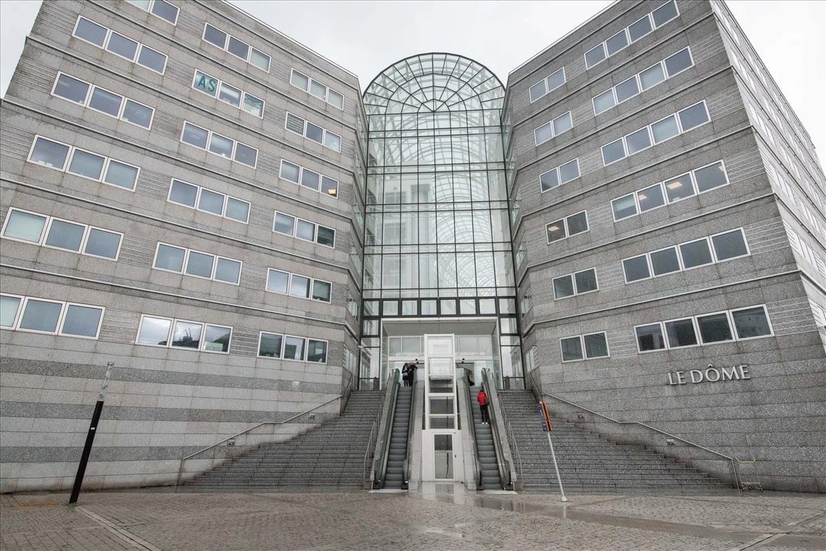 Exterior view of the grand stone and glass facade of Le Dôme.