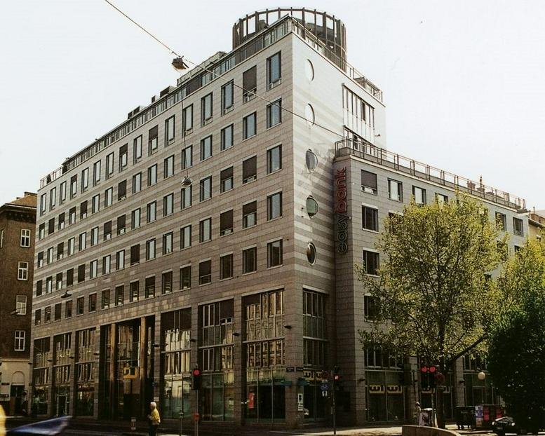 Exterior view of the mixed-use Martinstraße 54, Klosterneuburg building featuring a rounded glass top.