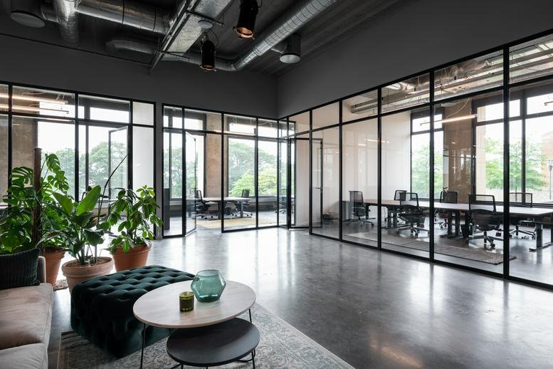 Spacious reception area at Philipssite, 5, Leuven, Belgium with glass partitions and potted plants.