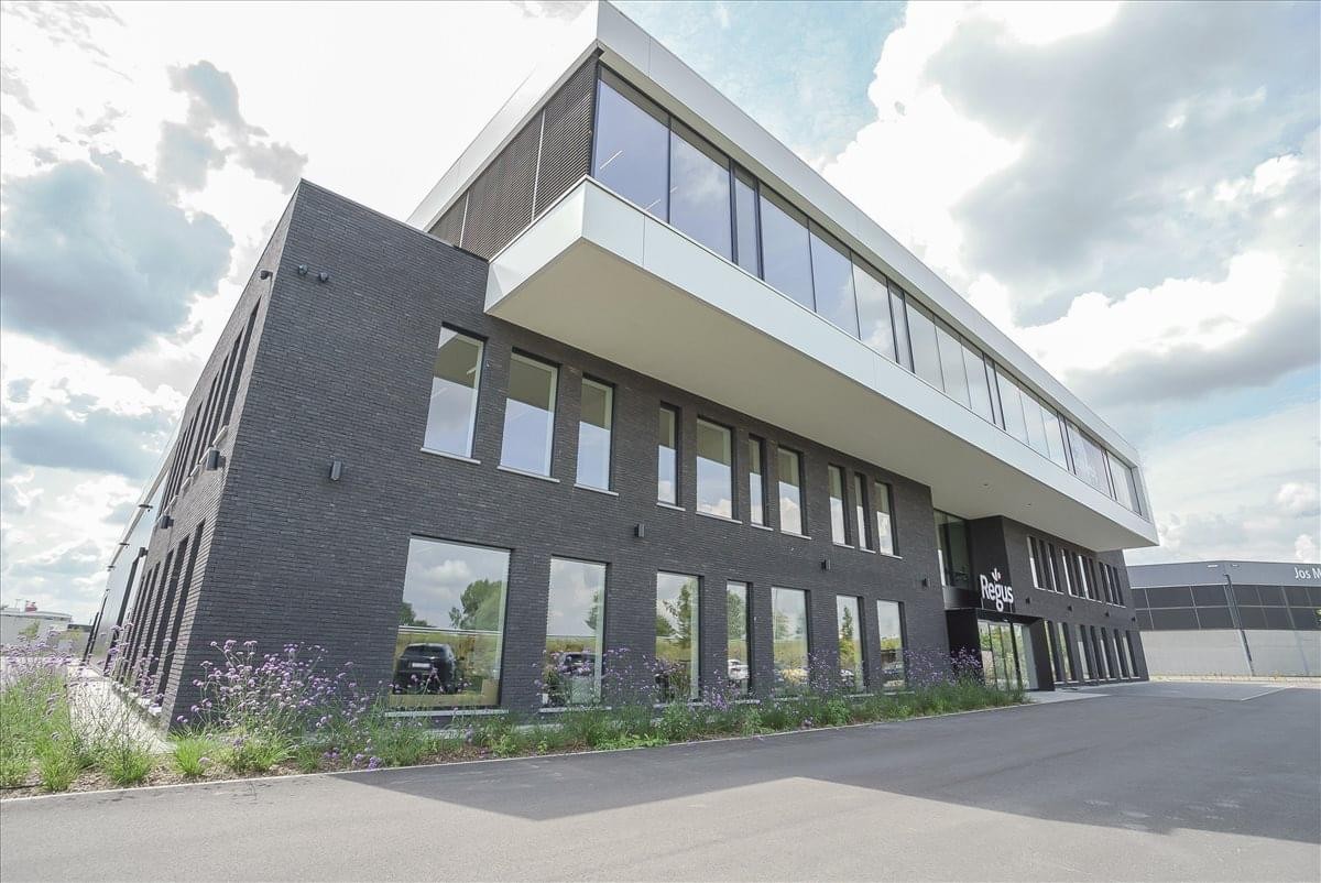 Exterior view of the modern dark brick and white cantilevered building of Regus Brecht, Ringlaan 17/A.
