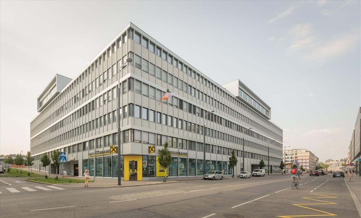 Exterior view of the modern, multi-story Square One office building with its prominent glass facade.