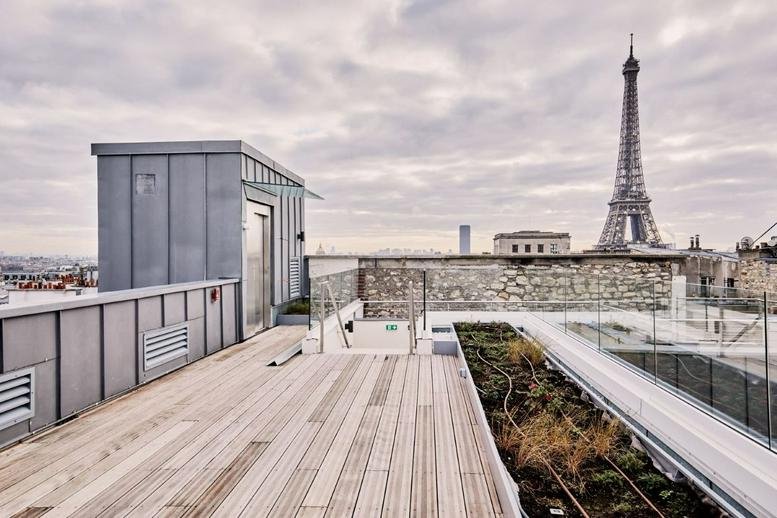 Rooftop terrace at Trocadero, 7 Rue Magdebourg, Paris with wooden decking and a clear view of the Eiffel Tower.