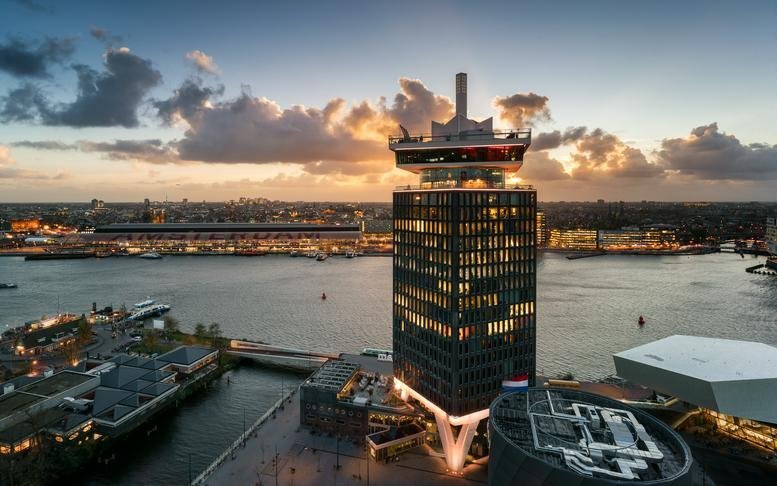 Exterior view of the landmark A'DAM Tower at Overhoeksplein 1, 1031KS Amsterdam during sunset.