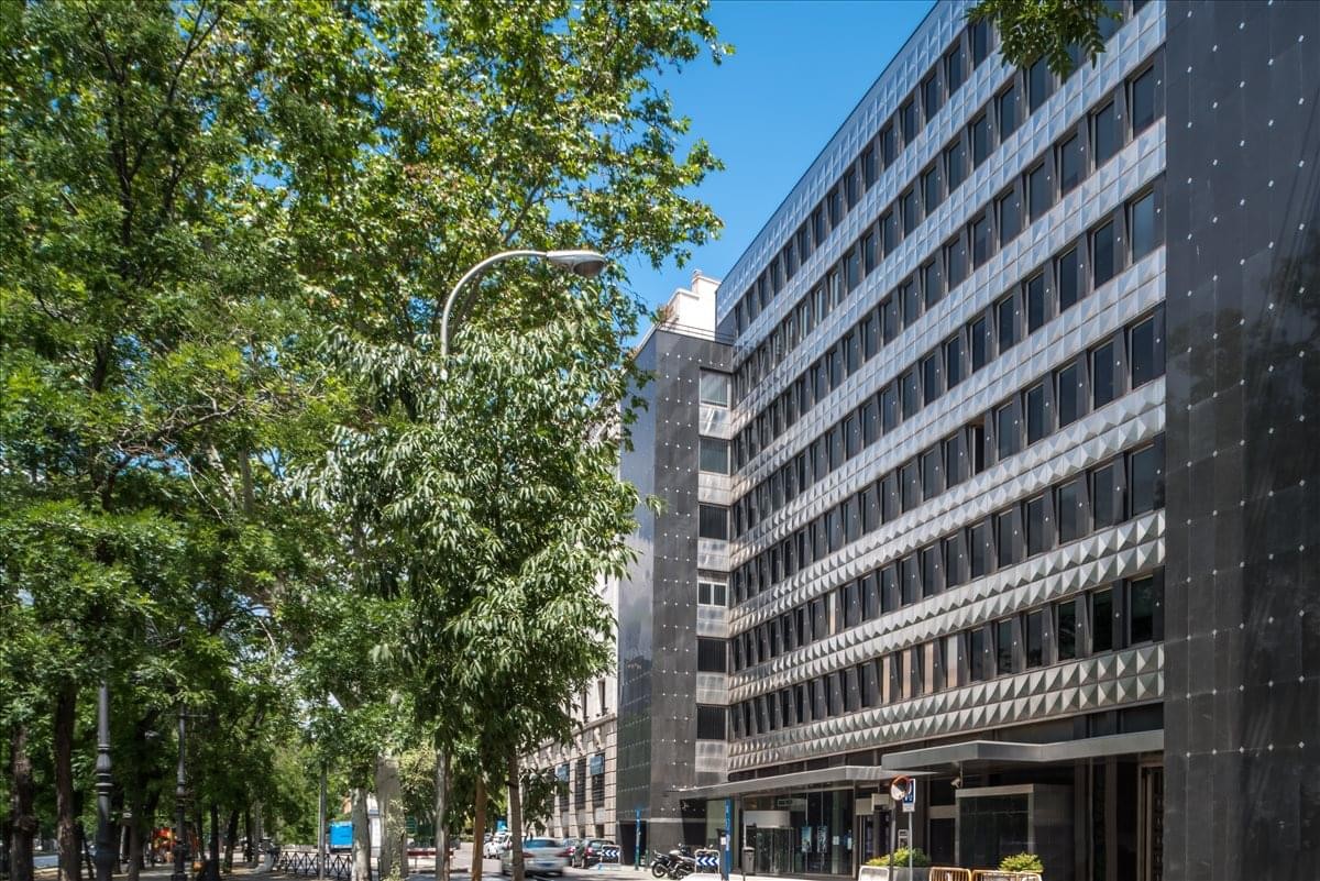 Exterior view of the dark-windowed office building at Paseo de la Castellana 18.